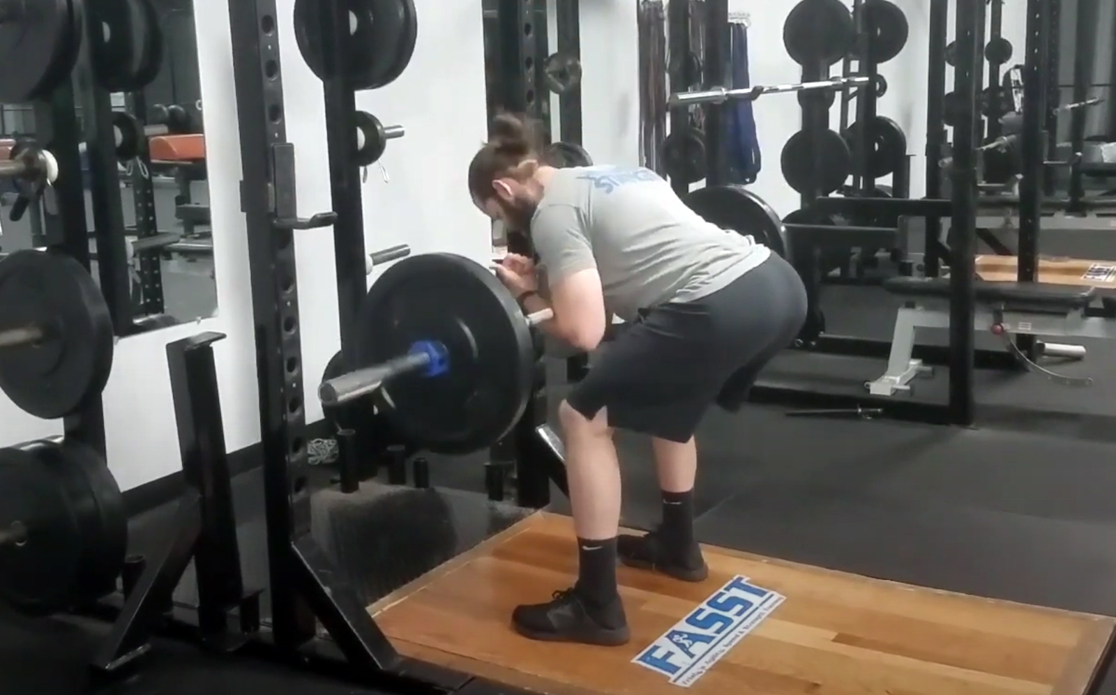 Person performing a Zercher good morning exercise for posterior chain strength